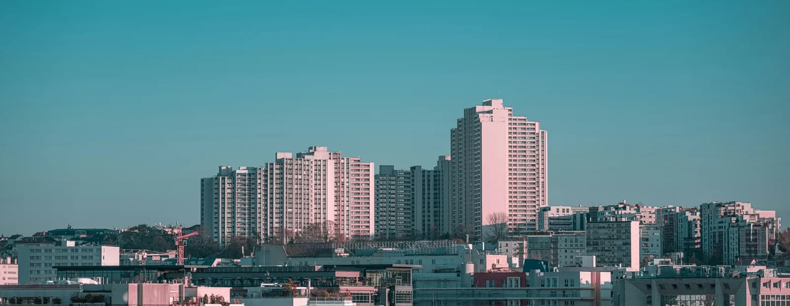 Vue d’ensemble d’un quartier résidentiel, tours d’habitation claires sous un ciel bleu uni et dégagé